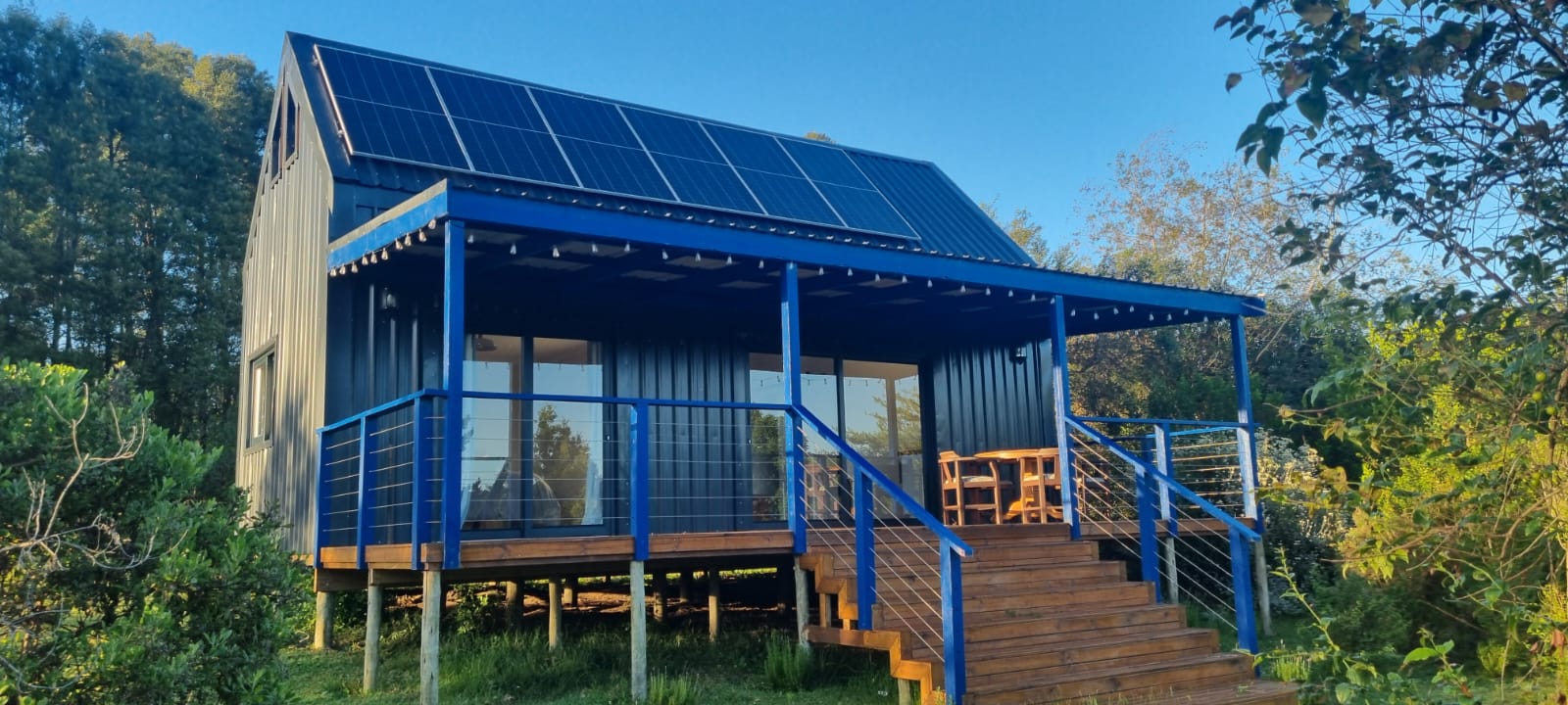 Loft Haven — exterior with solar panels and timber deck